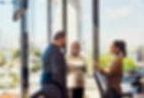 Three people talking in an office